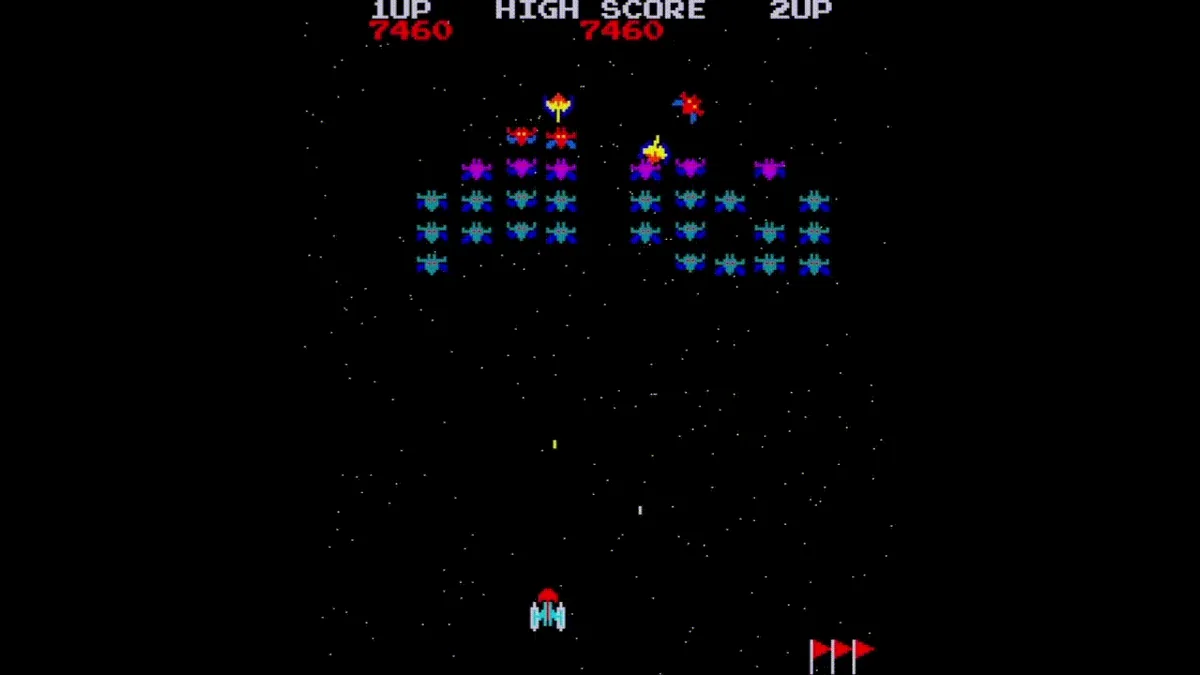 Partida en curso del motor Galaxian: la formación de enemigos, uno de ellos en picado, y la nave del jugador disparando